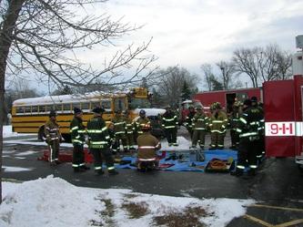 a group of firemen doing training outside in the snow