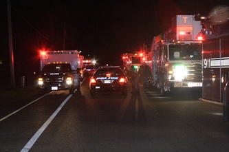 firetrucks police cars and ambulances with lights on at night